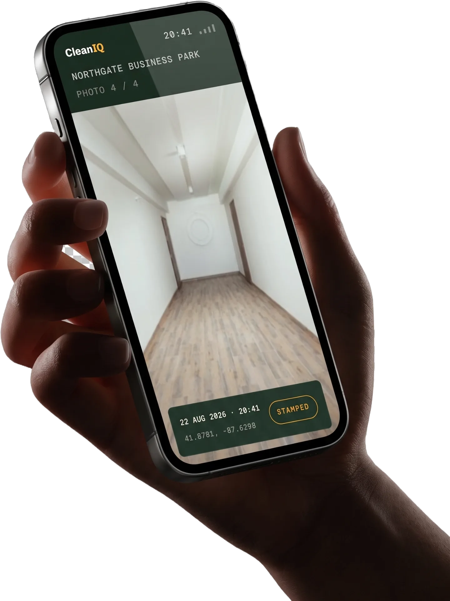 A hand holding a phone showing the CleanIQ photo-proof screen: a cleaned corridor photo with a date, time, location stamp bar reading Stamped. Interface preview, sample data.